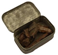 A small German tinplate box containing shrapnel fragments, 7.5 cm