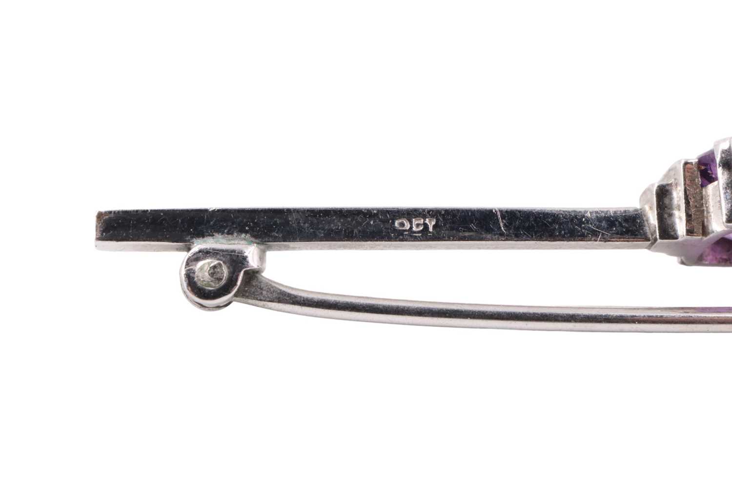 An Art Deco amethyst bar brooch, having a 6.5 x 6.5 mm cushion cut amethyst set between adorsed - Image 3 of 3