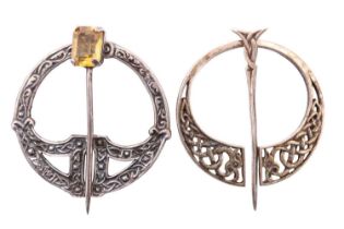 Two Scottish silver penannular brooches, one set with an emerald cut citrine, both having Celtic