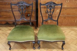 A pair of Edwardian carved mahogany nursing chairs, 76 cm