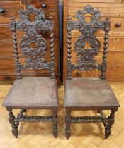A pair of 1930s carved oak standard chairs, 115 cm
