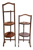 A set of two George V mahogany folding cakestands, being two and three tier, 71 cm and 95 cm