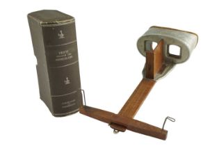 A Victorian stereoscope together with a book-form case for stereo views