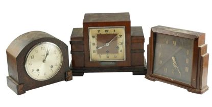 An Art Deco walnut mantle clock, striking and chiming on gongs, the case having stepped sides with