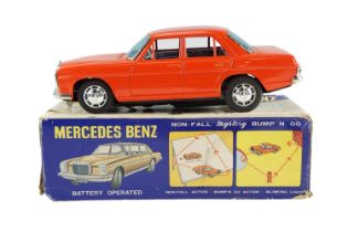 A boxed 1960s Mercedes Benz "Non-Fall Mystery Bump' N Go" battery-powered tin-plate toy car, by