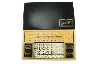 A vintage Schweppes "Play your cards right" cribbage board, cards, and dominoes set