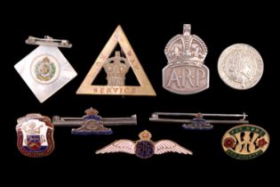 A small group of sweetheart brooches, Great War munitions workers' badges, a silver ARP badge etc