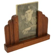 A 1940s oak photograph frame containing portraits of a Second World War Royal Tank Regiment soldier,