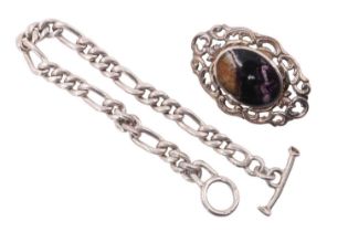 A Blue John set silver brooch, the oval cabochon in a bezel setting within scrolling openwork,