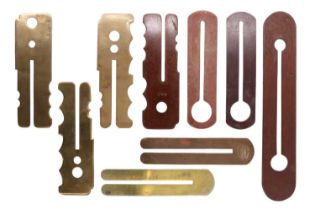A collection of button sticks / clothing protectors, two bearing service numbers, one of which
