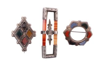 Three Victorian hardstone and pebble brooches, including an open white metal hexagon decorated