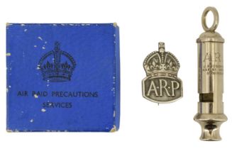 A Second World War ARP whistle together with an ARP silver badge in original carton