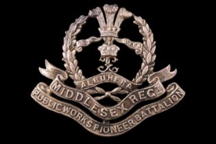 An 18th Battalion Middlesex Regiment (1st Public Works Pioneer Battalion) officer's cast cap badge