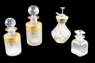 Three Edwardian gilt glass perfume bottles, including a graduated pair, together with an enamelled
