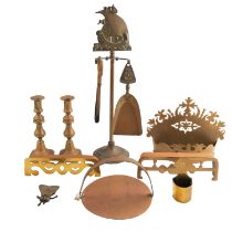 A quantity of antique brass domestic metalware, including Victorian brass candlesticks, a fireside