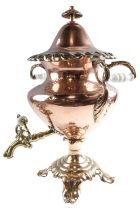 A William IV copper and brass tea urn, having milk glass handles, 50 cm tall