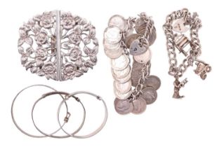A silver coin charm bracelet, a child's silver charm bracelet and three child's silver bangles