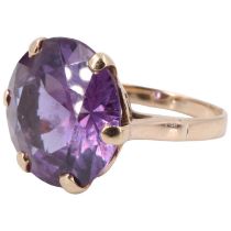An amethyst finger ring, the 14 mm round stone prong set on a pierced gallery between open