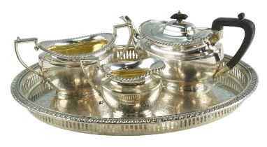 A three-piece electroplate tea set on a conforming oval tray