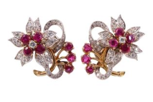 A pair of ruby and diamond floral earrings, each having a flowerhead of four 3 mm rubies centred