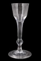 A mid 18th Century balustroid wine or cordial glass, having an ogee bowl and stem with low teared