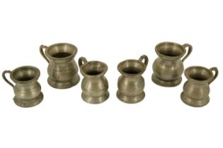 Six early 20th Century pewter baluster measures, 5.5 cm tallest