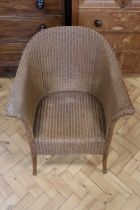 A 1930s Lloyd Loom arm chair, 79 cm