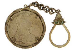 A silver Maria Theresia one thaler coin in a key-chain mount