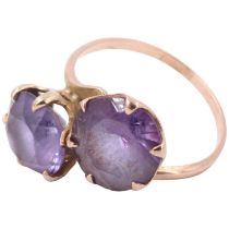 A vintage amethyst two stone crossover ring, having two 8.5 mm brilliants in crown settings