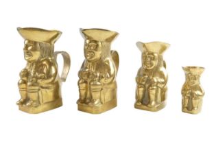 Four brass Toby jugs, tallest 14 cm