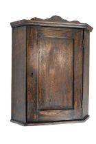 A diminutive early 20th Century oak corner cabinet, 41 cm high