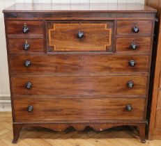 An early Victorian mahogany secretaire chest, having a central secretaire drawer, between a bonnet