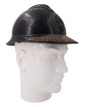 A Great War French infantry Adrian helmet with commemorative brass peak plate