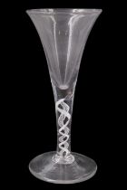 A mid 18th Century opaque twist wine glass, of drawn trumpet form, the stem having a ribbon and