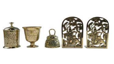 Three items of mid-to-late 20th Century Indian brass including a canister, folding book ends and a