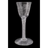 An old reproduction George III opaque twist stemmed wine glass, its ogee bowl decorated with wheel-