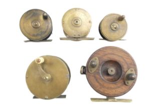 Four vintage brass centrepin fly fishing reels together with another reel, largest brass 8.5 cm