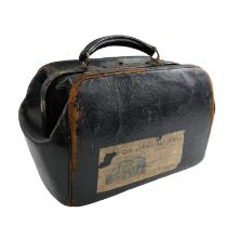 A late 19th Century leather Gladstone bag, bearing a paper luggage label of "The Grand Oriental