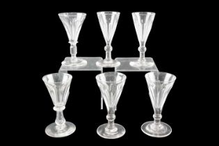 A set of four early 19th Century English wine glasses, having slice-cut conical bowls, together with