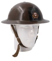 A Second World War British Red Cross Mk II steel helmet bearing an applied cap badge on a painted