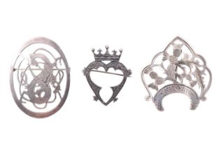 Three Scottish brooches, comprising a white metal brooch having a mythical beast among Celtic
