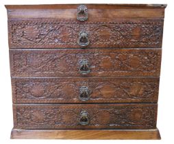 A mid 20th Century carved Indian hardwood jewellery cabinet, having three drawers and a hinged lid