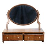 An early 19th Century mahogany dressing table / swivel toilet mirror, comprising an oblate mirror on