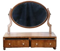 An early 19th Century mahogany dressing table / swivel toilet mirror, comprising an oblate mirror on