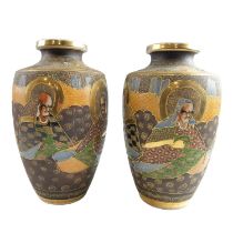 A pair of Japanese Satsuma vases, hand-enamelled in depiction of immortals within a moriage