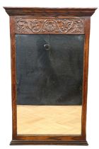 A late 20th Century carved oak pier glass / mirror by Jacee Furniture, Brighton, maker's label