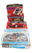 An ERTL 1:24 scale Crystal Ford Escort RS 1800 model kit together with an Airfix Mini Cooper 1:32