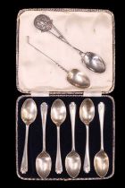 A cased set of six silver teaspoons, the terminals decorated with crossed golf clubs and a ball