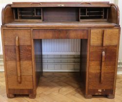 A 1930s Art Deco style oak tambour / roll top desk having automatic latching side drawers by William