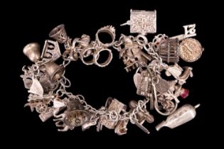 A silver and white metal charm bracelet together with a quantity of loose charms, late 20th Century,